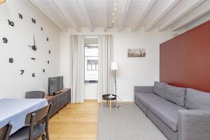 a living room with a couch and a tv at CityLife in Bergamo