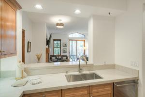 a kitchen with a sink and a large mirror at Lodge at Brookside, A Vail Resorts Property in Avon +65 photos