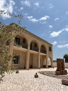 a large brick building with an archway in a courtyard at Villa Arneide bed and breakfast in Torre Lapillo