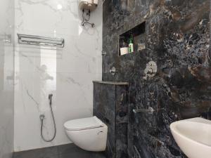 a bathroom with a toilet and a sink at RVS Chalet in Pondicherry +96 photos