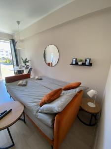 a bedroom with a bed with pillows and a mirror at Baltic Garden Stay in Kołobrzeg