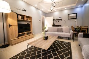a living room with a couch and a table at HOMEY iNN in Medina