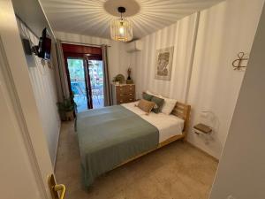 a bedroom with a bed and a chandelier at El Bohemia Tenerife zuid strand rust en 3 zwembaden in Palm-Mar +64 photos