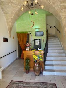 a hallway with a staircase with a vase of flowers at Villa Arneide bed and breakfast in Torre Lapillo