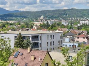 a view of a city with buildings and trees at Modern stylish apartment in Prievidza