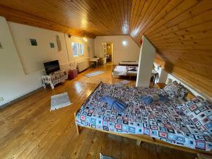 a large bed in a room with a wooden ceiling at Casa Dalia 2 in Sighişoara
