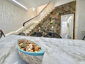 a basket of seashells on a table in a house at Castello di Sabbia in Trabia