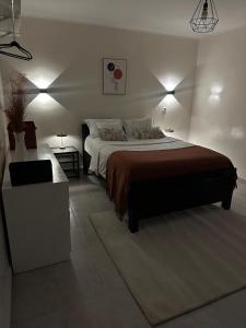 a bedroom with a large bed and a desk at Mne villa 3 chambres in Douala