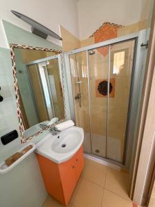 a bathroom with a sink and a shower at Villa Arneide bed and breakfast in Torre Lapillo +98 photos