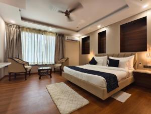 a hotel room with a large bed and a desk at Jakk Residency, ILBS Hospital in New Delhi