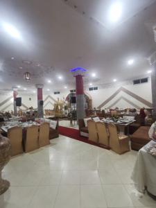 a restaurant with couches and tables in a room at reda land in Ben Slimane