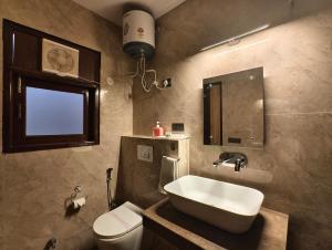 a bathroom with a sink and a toilet at Jakk Residency, ILBS Hospital in New Delhi +62 photos