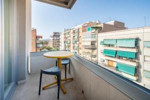 a yellow table and chair on a balcony with a view at Sun & Moon Barcelona Airport in El Prat de Llobregat