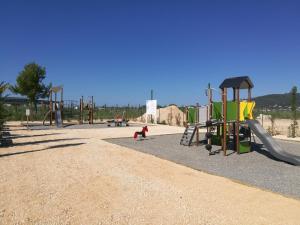 an empty park with a playground with a slide at Mobil-home DURIS in Hyères +4 photos