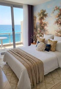 a bedroom with a large bed with a view of the ocean at Beachfront Central Boutique Apartments in Durrës +168 photos