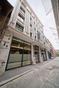a large white building with large windows on a street at Elysia Hotel in Istanbul