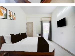 a bedroom with a large bed with white walls at Hotel Galaxy Inn in Greater Noida