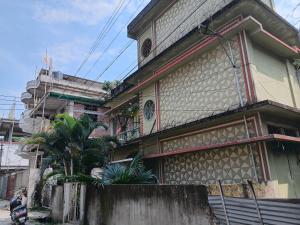 a building with a tree in front of it at Saurabh home stay in Dibrugarh