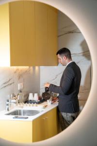 a man standing in a kitchen preparing food at Sun & Moon Barcelona Airport in El Prat de Llobregat +70 photos