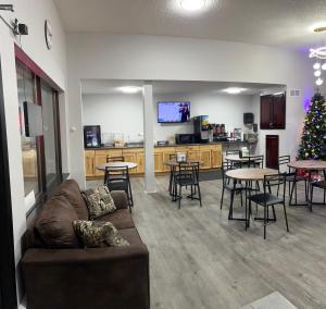 a living room with a couch and tables and a christmas tree at Northern Lights Inn in Park Falls