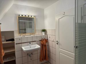 a bathroom with a sink and a mirror at Ferienwohnung Fluss & Fels in Stadt Wehlen