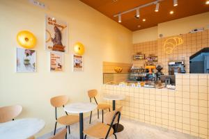 a restaurant with two tables and a counter at Sun & Moon Barcelona Airport in El Prat de Llobregat