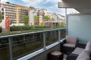 a balcony with a couch and a chair and some buildings at Zilte bries in Nieuwpoort
