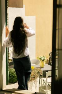 a woman standing outside a window talking on a cell phone at Casa Regina, nice position! in Alba
