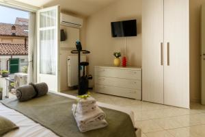 a bedroom with a bed and a dresser at Casa Regina, nice position! in Alba