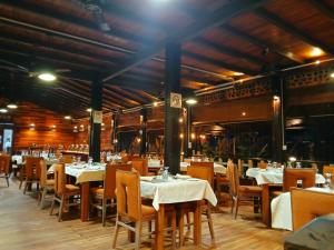 a restaurant with tables and chairs with white table cloth at Blue Sand Beach Resort in Trincomalee