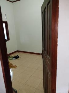 an open door to a room with a tile floor at Kahardi guest house in Sengkol +1 photo