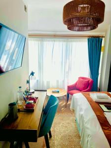 a bedroom with a bed and a table and a bed and a room at George Hotel & Granary in Frome