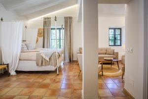 a bedroom with a bed and a living room at Posada del Marqués I A Slow Design Hotel in Esporles