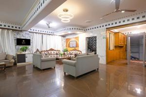 a large living room with chairs and a table at Hotel Tela Suite Near IGI Airport Delhi in New Delhi