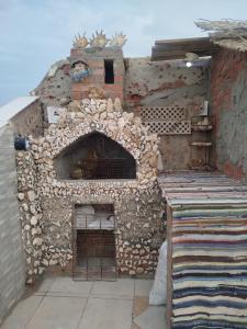 a large brick oven with a stone wall at Sky Roof Suite in Marsa Alam City