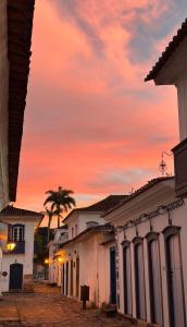 a group of buildings with a sunset in the background at Studio Hashi 04 in Paraty