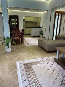 a living room with a couch and a table at Leila Home Garden - Maamourah Beach in Alexandria