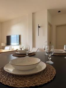 a table with two plates and wine glasses on it at Fajana de Trevejo in Garachico +10 photos