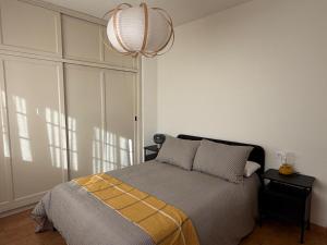 a bedroom with a bed and a chandelier at Fajana de Trevejo in Garachico