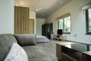 a living room with a couch and a bed at Rare Aura Villa in Dod Jāla