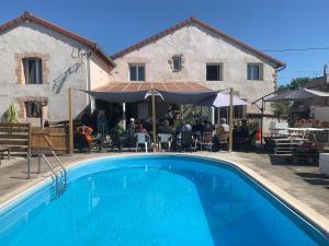 a large swimming pool in front of a building at La Varenne in Changy