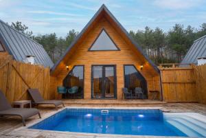 a log house with a pool in front of it at Morrian Sapanca in Sapanca