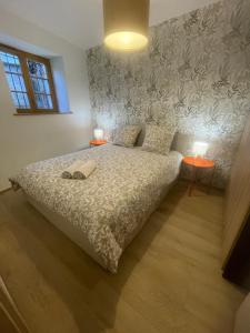 a bedroom with a bed with two lamps on it at Chez Mamema in Barr