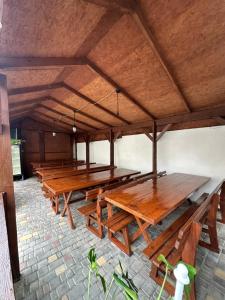 a row of wooden tables in a room at Villa Bossa in Zatoka