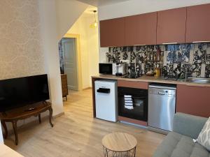 a living room with a kitchen and a couch at Chez Mamema in Barr