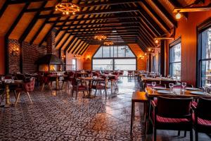 a restaurant with wooden ceilings and tables and chairs at Morrian Sapanca in Sapanca