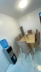 a room with a table and chairs and a trash can at Mombasa city view in Mombasa +2 photos