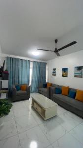 a living room with couches and a ceiling fan at Mombasa city view in Mombasa