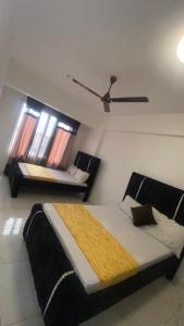 a bedroom with a large bed and two windows at Mombasa city view in Mombasa