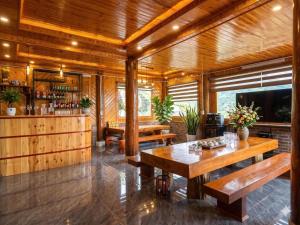 a room with wooden walls and tables and a bar at Sapa Rock Hill Homestay in Tả Van